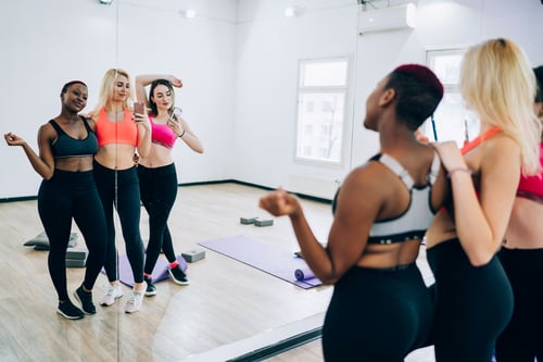 ClubOS | Women taking selfie in yoga class